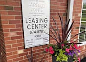 Thumbnail 73 of 74 - A sign for a leasing center is displayed on a brick wall.